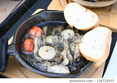 Ajillo with plenty of ingredients including shrimp, mushrooms, and cherry tomatoes Ajillo with plenty of ingredients including shrimp, mushrooms, and cherry tomatoes 136720935