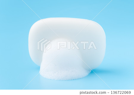 一塊白色的肥皂和泡泡，背景是淺藍色背景。 136722069