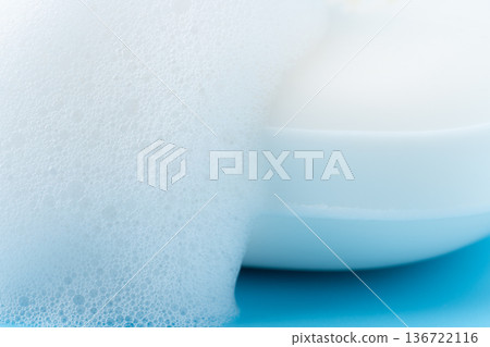 Close-up of lathered white bar soap on a light blue background Close-up of lathered white bar soap on a light blue background 136722116