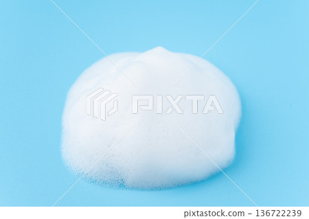 White soap bubbles on a light blue background White soap bubbles on a light blue background 136722239