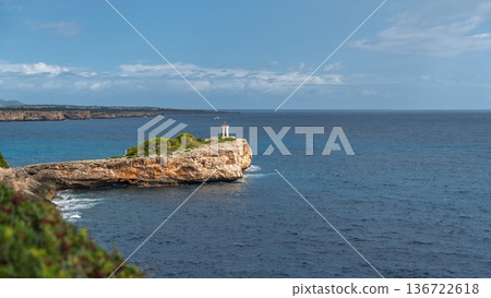Picturesque Coastal View in Mallorica, Spain Tranquil Seascape with Rocky Cliffs and Lighthouse Picturesque Coastal View in Mallorica, Spain Tranquil Seascape with Rocky Cliffs and Lighthouse 136722618
