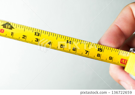 Precision Tape Measurement Tools in Hand 136722659