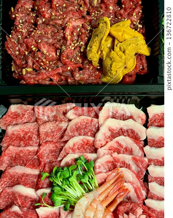 Fresh yukhoe with finely sliced raw beef, seasoned with soy sauce, sesame oil, and spices, topped with a rich egg yolk. A flavorful and delicate Korean delicacy, perfect for meat lovers! 136722810