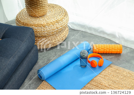 Yoga mat and accessories are set up for a home workout Yoga mat and accessories are set up for a home workout 136724129