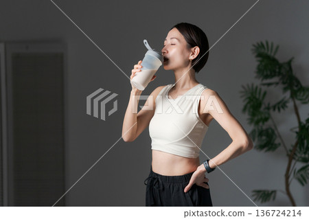 Woman drinking protein Woman drinking protein 136724214