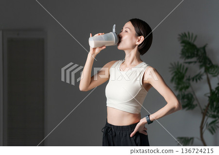  Woman drinking protein 136724215