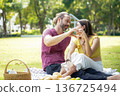 Happy family picnic in the park public on summer holiday.  Family relax and enjoying outdoor.   136725494