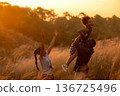 Happy African family father and child daughter travel and running on meadow  136725496
