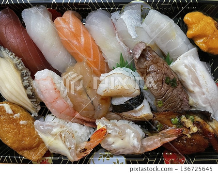 An assortment of fresh sushi, artfully arranged with a variety of toppings and vibrant colors. This traditional Japanese dish combines vinegared rice, seafood, and vegetables for an experience. An assortment of fresh sushi, artfully arranged with a variety of toppings and vibrant colors. This traditional Japanese dish combines vinegared rice, seafood, and vegetables for an experience. 136725645