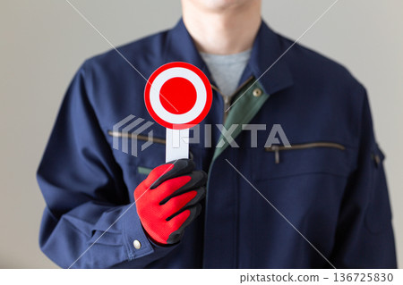 A middle-aged male businessman in work clothes holding a round plate 136725830