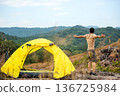 Lifestyle man travel hiker adventure and tent camping on mountain nature landscape. 136725984