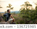 Hiker man backpack walking trail activity camping outdoors for destination leisure. 136725985