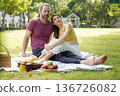 Happy family picnic in the park public on summer holiday.  Family relax and enjoying outdoor.  136726082