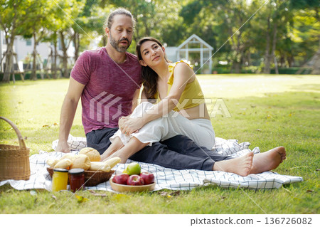 Happy family picnic in the park public on summer holiday. Family relax and enjoying outdoor. Happy family picnic in the park public on summer holiday. Family relax and enjoying outdoor. 136726082