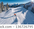 Skier sliding down a snowy mountain 136726795