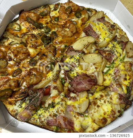A delicious pizza with a golden crust, melted cheese, and savory toppings. Perfect for food-related designs, menus, or Italian-themed projects, capturing the essence of a classic comfort dish. 136726925