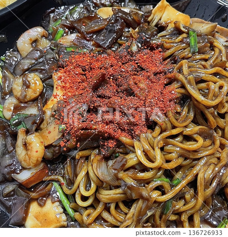 Classic jajangmyeon with thick noodles in a rich black bean sauce, garnished with sliced cucumber and sesame seeds. A beloved Korean-Chinese comfort dish, full of savory depth and flavor. Classic jajangmyeon with thick noodles in a rich black bean sauce, garnished with sliced cucumber and sesame seeds. A beloved Korean-Chinese comfort dish, full of savory depth and flavor. 136726933