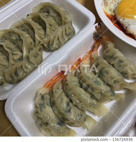 Korean dumplings filled with a mix of savory ingredients like ground meat, tofu, and vegetables. Mandu can be steamed, boiled, or pan-fried, making it a versatile and delicious snack or meal. 136726936