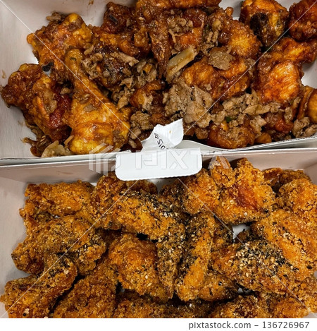 Crispy Korean fried chicken, perfectly glazed with a sweet and spicy sauce. Ideal for food photography and menus, showcasing the irresistible crunch and flavor of this beloved dish. Crispy Korean fried chicken, perfectly glazed with a sweet and spicy sauce. Ideal for food photography and menus, showcasing the irresistible crunch and flavor of this beloved dish. 136726967
