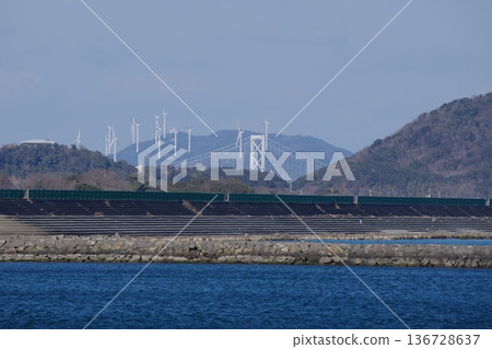 In the distance, the Onaruto Bridge and wind power generation on Awaji Island 136728637