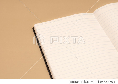 A blank notebook placed on a brown background A blank notebook placed on a brown background 136728704
