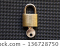 A locked padlock on a black mat 136728750