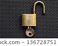 An unlocked padlock on a black mat 136728751