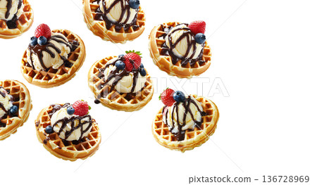 Multiple waffles topped with ice cream, chocolate and berries isolated on white background, concept of sweet dessert 136728969