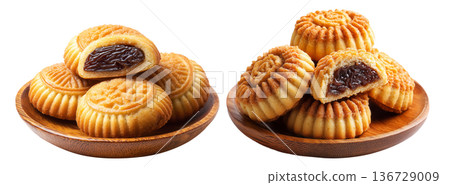 Traditional Maamoul cookies, one halved showing date and nut filling, isolated on white background, concept of Arabic desserts Traditional Maamoul cookies, one halved showing date and nut filling, isolated on white background, concept of Arabic desserts 136729009