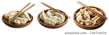 Pan-fried or steamed dumplings Jiaoz arranged on a wooden plate, isolated on white background, concept of Asian cuisine Pan-fried or steamed dumplings Jiaoz arranged on a wooden plate, isolated on white background, concept of Asian cuisine 136729016