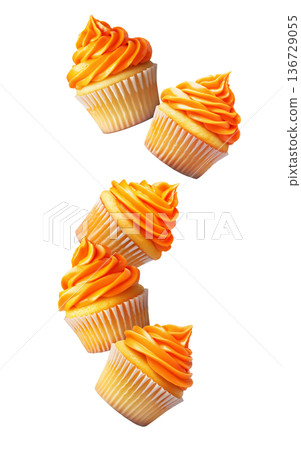 Multiple orange frosted cupcakes scattered in a seamless pattern isolated on a white background, concept of dessert variety Multiple orange frosted cupcakes scattered in a seamless pattern isolated on a white background, concept of dessert variety 136729055