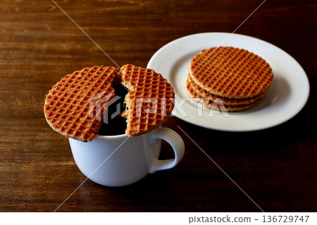 Two stroopwafels and coffee on the table background Two stroopwafels and coffee on the table background 136729747