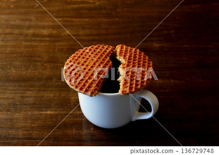 Two stroopwafels and coffee on the table background Two stroopwafels and coffee on the table background 136729748