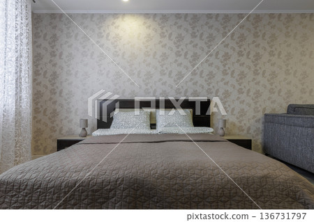 Modern Studio Apartment Interior with Bed and Floral Wallpaper Modern Studio Apartment Interior with Bed and Floral Wallpaper 136731797
