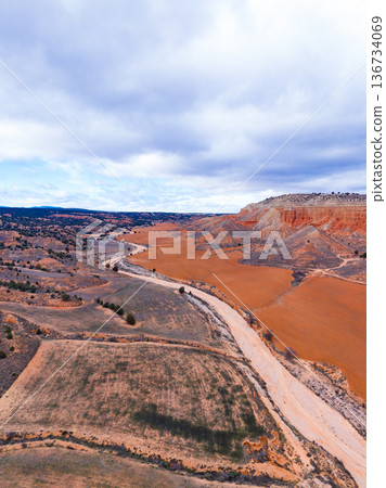 Canyon view in Teruel shows dry landscape and winding river under cloudy sky 136734069