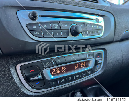 Control panel in a car showing radio settings and climate control options during daylight hours Control panel in a car showing radio settings and climate control options during daylight hours 136734152