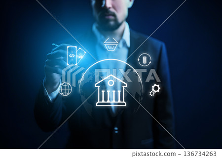 Man shows banking services with icons and symbols on dark background Man shows banking services with icons and symbols on dark background 136734263