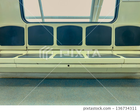 Empty train seating area in a modern subway system during midday in a large city Empty train seating area in a modern subway system during midday in a large city 136734311