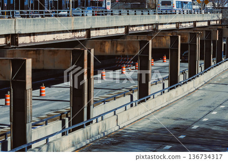 Construction work on highway with barriers in urban area during daylight hours 136734317