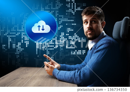 Man uses smartphone to interact with cloud technology in a digital environment 136734350