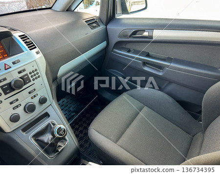 Interior of a car showing the dashboard and driver's seat during winter season Interior of a car showing the dashboard and driver's seat during winter season 136734395