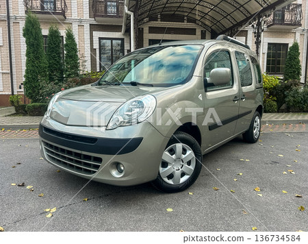 Small gray van parked in front of a building with trees and a path during daytime Small gray van parked in front of a building with trees and a path during daytime 136734584
