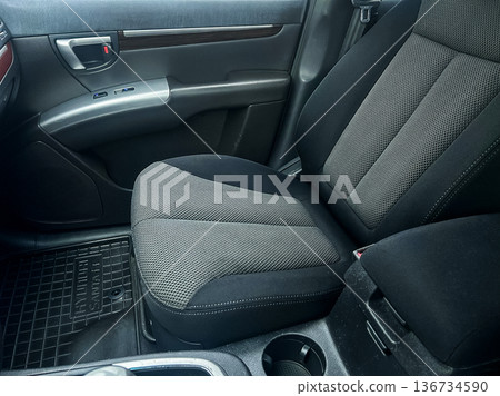Car interior showing a driver seat with fabric design, located in a modern vehicle, taken during daylight Car interior showing a driver seat with fabric design, located in a modern vehicle, taken during daylight 136734590