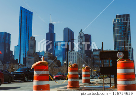 Construction barriers block a street in downtown Chicago with skyscrapers in the background on a clear day Construction barriers block a street in downtown Chicago with skyscrapers in the background on a clear day 136734639