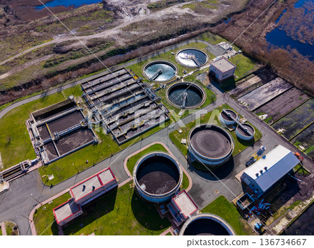 Water treatment plant shows various tanks and facilities for processing wastewater in a detailed view taken from the sky Water treatment plant shows various tanks and facilities for processing wastewater in a detailed view taken from the sky 136734667