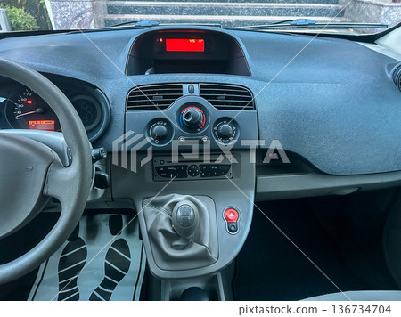 Dashboard of a car showing controls and audio system in a parked vehicle during daytime Dashboard of a car showing controls and audio system in a parked vehicle during daytime 136734704