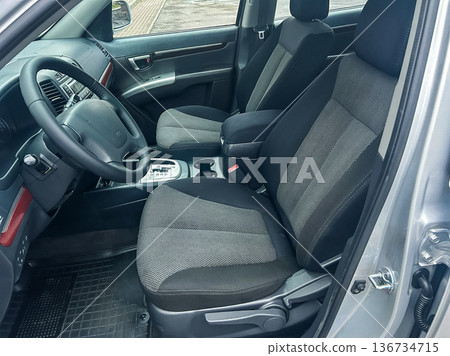 Vehicle interior shows front seats and dashboard with gear shift in a parked car at a location with no visible surroundings during daylight Vehicle interior shows front seats and dashboard with gear shift in a parked car at a location with no visible surroundings during daylight 136734715