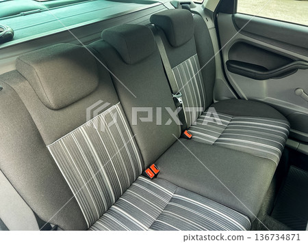 Rear seats in a compact car show modern design and comfortable seating arrangement for passengers during a drive Rear seats in a compact car show modern design and comfortable seating arrangement for passengers during a drive 136734871
