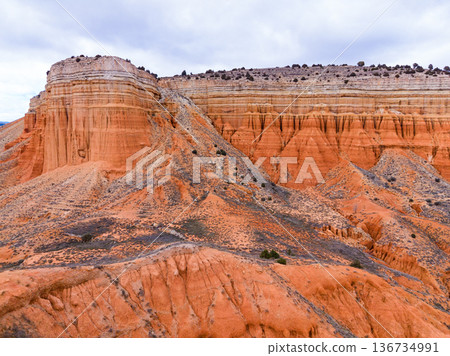 Scenic view of a canyon showing layers of rock and soil at midday during a cloudy day in the desert landscape 136734991