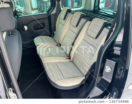 Interior view of a compact vehicle showing back seat arrangement with striped upholstery in a snowy area Interior view of a compact vehicle showing back seat arrangement with striped upholstery in a snowy area 136734996